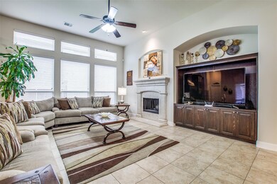 Living room with ceiling fan and light tile floori