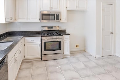 Kitchen featuring light tile patterned flooring, s