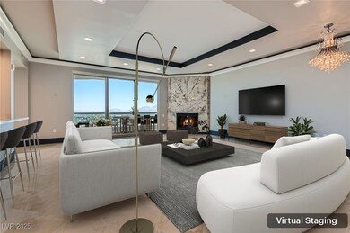 Living room with a tray ceiling, baseboards, reces