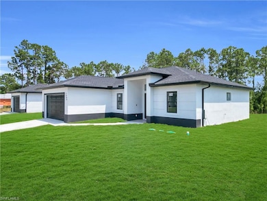 Prairie-style home with stucco siding, a front lawn, an attached garage, concrete driveway, and a shingled roof