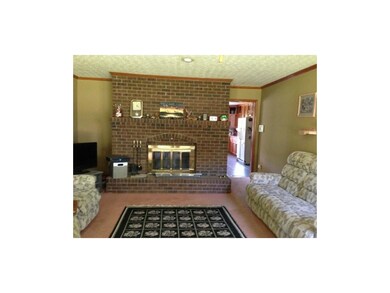 Spacious living room has beautiful wood burning fi