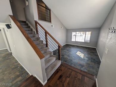 Stairway with stone finish flooring, baseboards, v