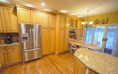 Bright kitchen with crown molding, hardwood floors