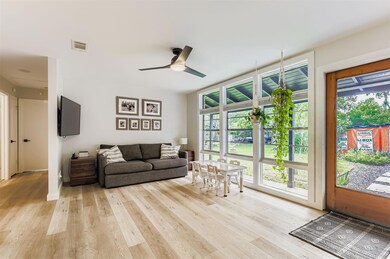 Living area featuring light wood-style floors, pl