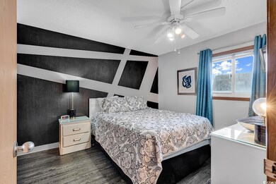 Bedroom with dark wood-style flooring and ceiling 