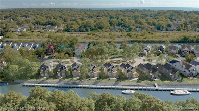 Aerial view of property's location featuring a large body of water and nearby suburban area