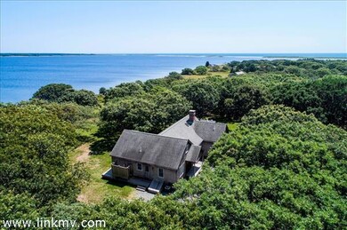 The house looks out over miles of open blue water, with views of Tisbury Great Pond and the Atlantic.