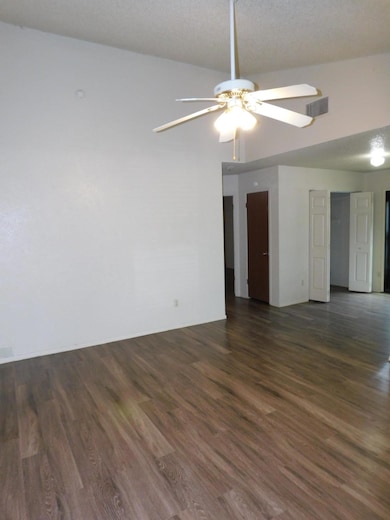 Empty room featuring a ceiling fan, visible vents