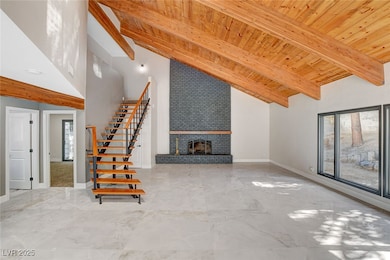 Unfurnished living room with stairway, baseboards,
