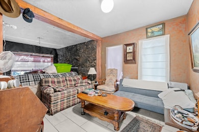 Living/Dining room with fireplace and large south and west facing windows