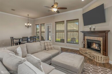 Living room with dark wood finished floors, crown 
