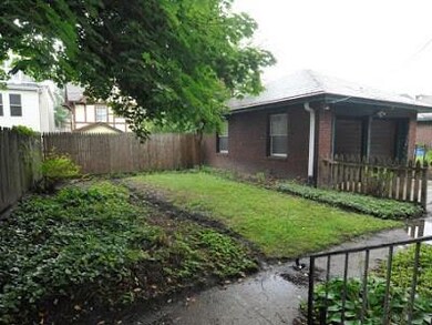A small back porch opens to the garden and two car