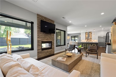 This inviting living area boasts ample space and is enhanced by impressive 10-foot ceilings, creating an open and airy atmosphere perfect for comfortable living and entertaining.