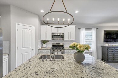 The large island makes for a great gathering spot for your friends and family.