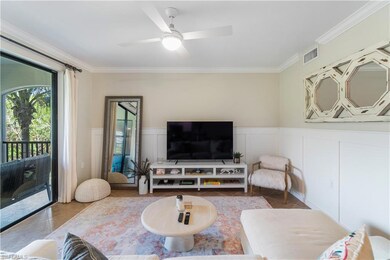 Living room with crown molding and ceiling fan