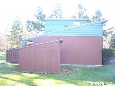 Exterior Front. Side view of home and shed showing