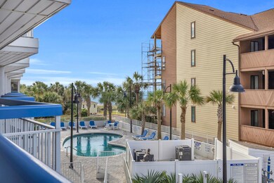 Community pool with a patio area and fence