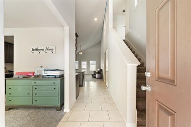 Welcoming entryway with soaring ceilings and a bri