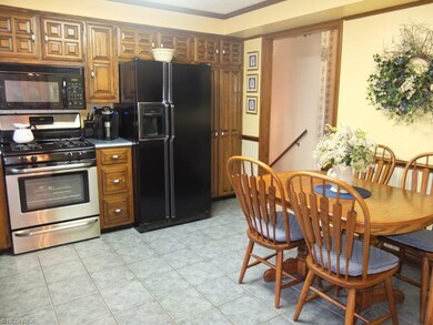 Eat-in kitchen has tile backsplash and stainless s