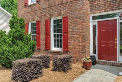 View of exterior entry featuring brick siding