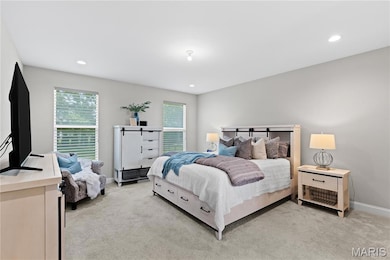 Bedroom with light carpet and recessed lighting