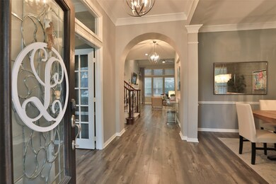 Upon entering, you're greeted with wide plank laminate flooring, updated light fixtures, a cozy study with double French glass doors and the dining room.