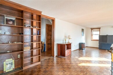Built in book shelves and parquet wood flooring.