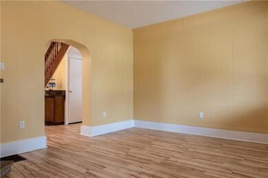 A graceful arch leads from living to dining room