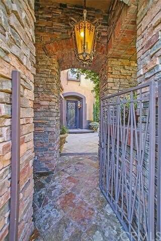 Gated entry featuring stone and brick.
