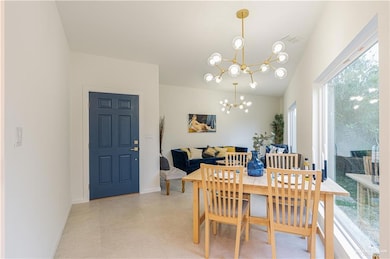 Dining space featuring a chandelier and baseboards