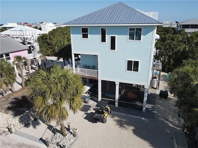 Back of house with a balcony, metal roof, and a pa