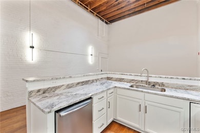 Kitchen featuring stainless steel dishwasher, ligh