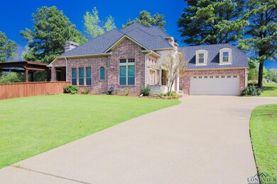 View of front of property with driveway, brick sid