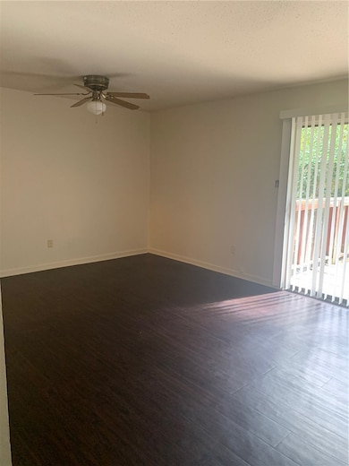 Unfurnished room with ceiling fan, baseboards, and