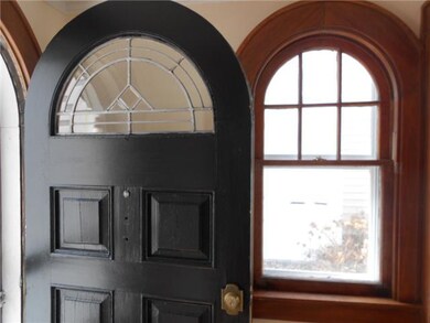 Exterior Front. The formal entry has an arched fro