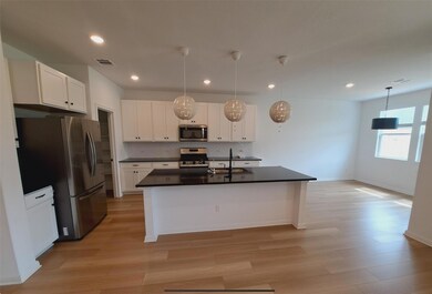 Kitchen featuring stainless steel appliances, dar