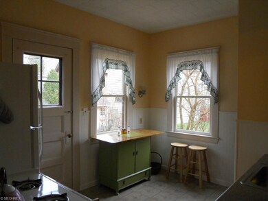 Bright kitchen eating area with door to back porch, patio and yard.