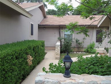 Entrance to property featuring a shingled roof