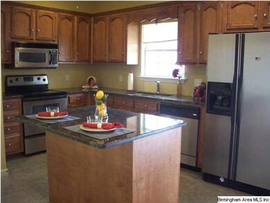 Granite covered island, refrigerator stays