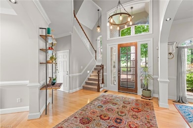 An open and airy foyer, complete with impressive arched openings and beautiful hardwood floors.
