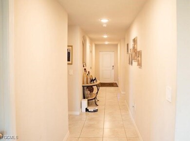 Hall with light tile patterned floors and baseboards
