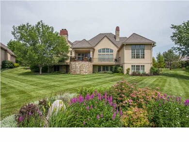BACK VIEW OF HOME WITH LUSH LANDSCAPING
