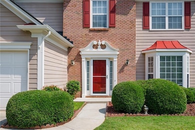 Property entrance featuring brick siding and a garage