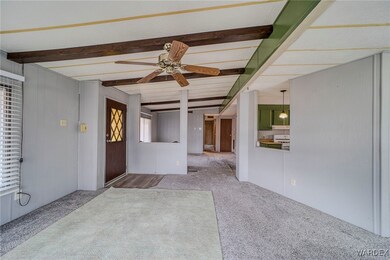 Carpeted spare room with beam ceiling and ceiling