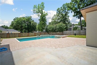 View of swimming pool with a patio, a pool with connected hot tub, and a fenced backyard