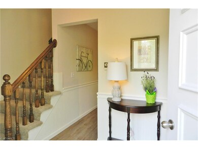 The charming foyer  is freshly painted with new la