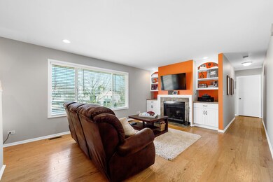Hardwood flooring and fireplace with built-in shel