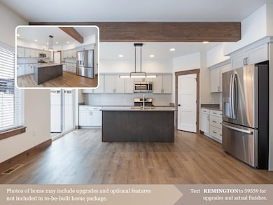 Kitchen with a center island with sink, beamed ceiling, stainless steel appliances, tasteful backsplash, and recessed lighting