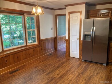 Kitchen featuring decorative light fixtures, stain