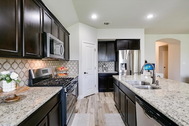 Kitchen featuring stainless steel appliances, a s